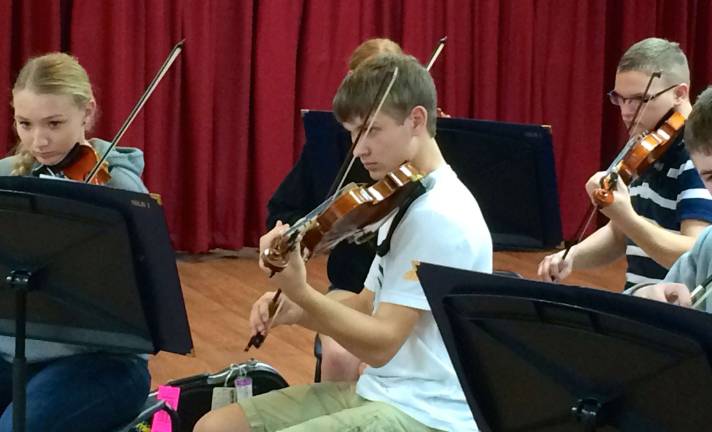 VTHS orchestra, choir performs in Disney World From left, Shanon Turner, Trevor Hazell and Paul Dwornicki are shown on the violins.
