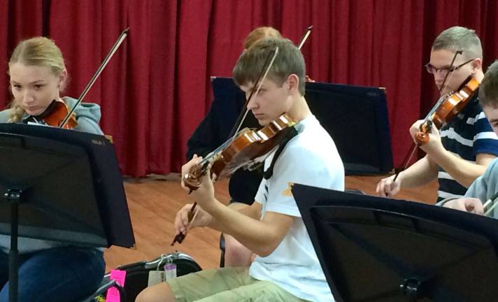 From left, Shanon Turner, Trevor Hazell and Paul Dwornicki are shown on the violins.