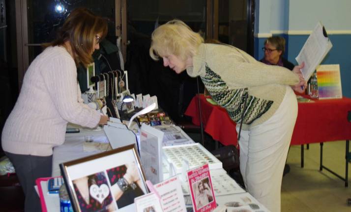 Elks member Carol Lee Spages peruses South Hill Designs make it yourself jewelry offered by Kelly Robertazzi of East Hanover.