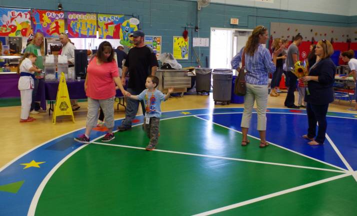 Young children and their parents were able to explore the gymnasium floor of the multi-purpose room.
