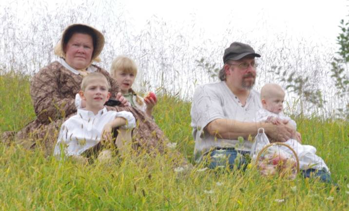 Visitors, including some in costume, watched the skirmish from a hill above the battlefield.