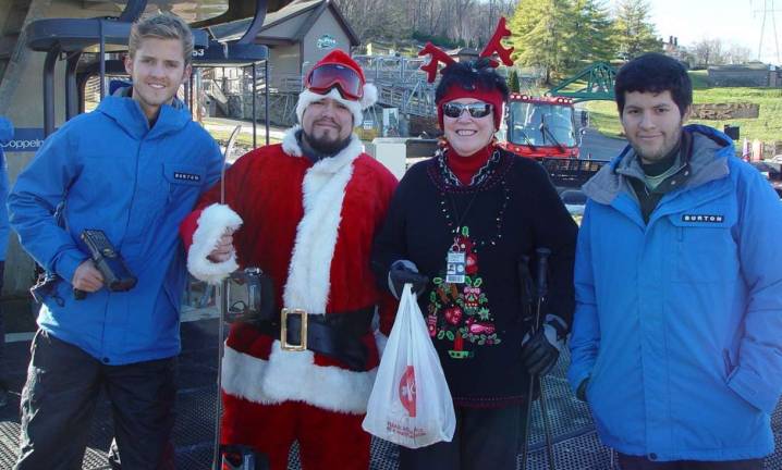 Santa Claus visits Mountain Creek From left, Rubin Romas, Santa, Buffy Whiting and Ignacio Vocos.