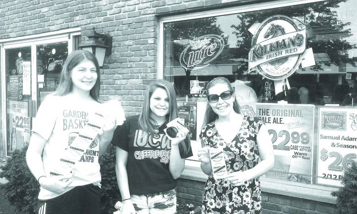 Sticker Shock Campaign to prevent underage drinking Pictured with a supply of stickers is Ayla Satter, Community Educator of CFPC, and the CTI youth group in action at Burke’s. Cpl. Sue Parkes of the Sparta Police Department and Tina Thompson, CTI Coordinator from the Center for Prevention and Counseling, also joined in this event.