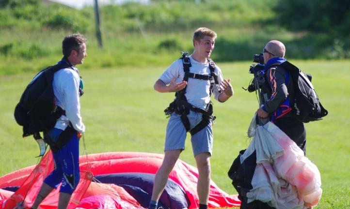 An excited eighteen year old Finnigan McGinley of Mendham, New Jersey is interviewed by a skydiver instructor about his first jump he just accomplished.