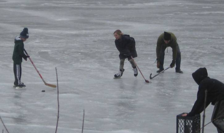 PHOTOS BY JANET REDYKE Hockey skaters take to the ice on one of Highland Lakes lake rinks.