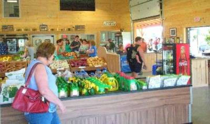 Customers browse the selection at the new Tranquillity Farms Market and Garden Center.