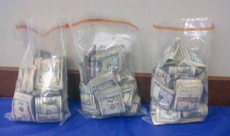 Photo provided by New York State Police Police said this the cash confiscated during Thursday's raids.