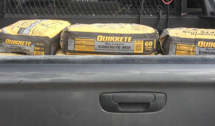 Concrete waits in a volunteer's pick-up truck for the next construction phase.