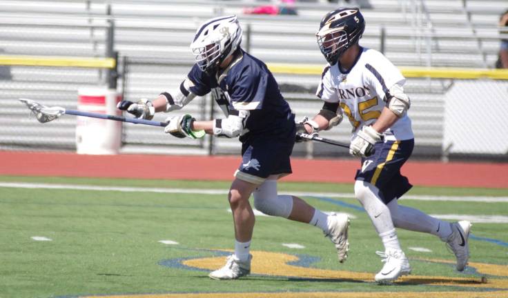 Pope John's Dane Armstrong carries the ball while shadowed by Vernon's Zack Biango.