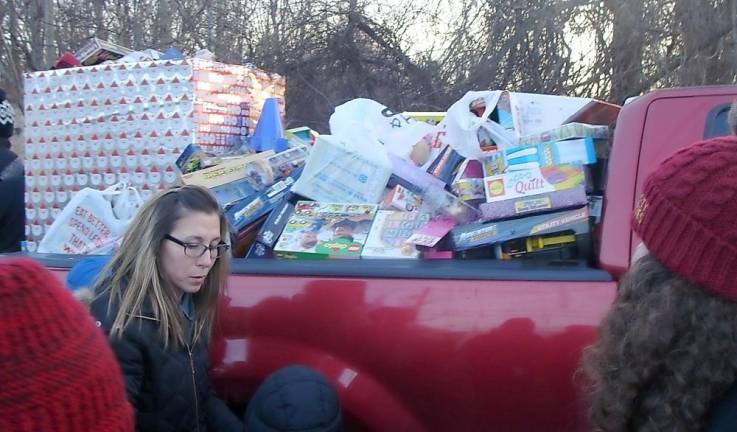 Unwrapped toys overflow in a pick-up truck waiting to be loaded onto the train.