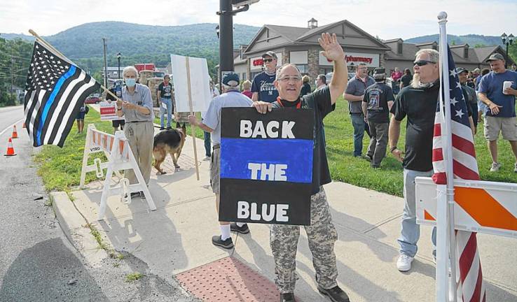 Organizer Martin O'Donnell with Back the Blue sign.