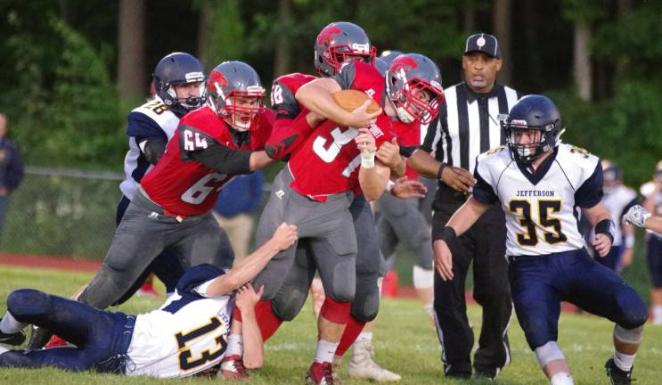 High Point ball carrier Chad Musilli gets his leg grabbed by Jefferson defender Paul Monaco in the first quarter.