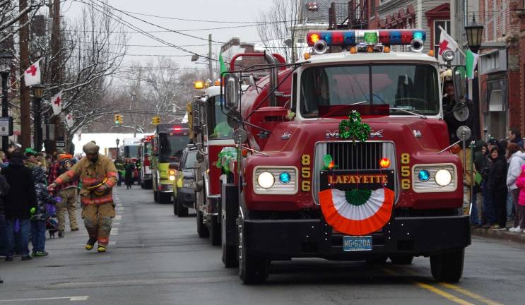 An old-style Lafayette fire truck rolls down the street during the Sussex County St. Patrick's Day parade.