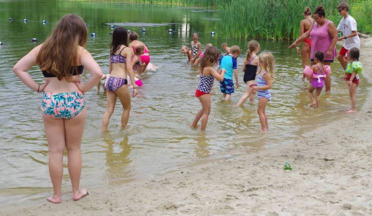 The children searched the shallows for pennies wrapped in aluminum foil.