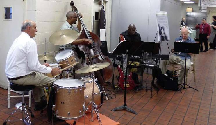 Taste of Talent event supports Project Self-Sufficiency The entire building, including the kitchen, was included in the event. Here a band entertains guests as they stroll through the kitchen at Perona Farms.