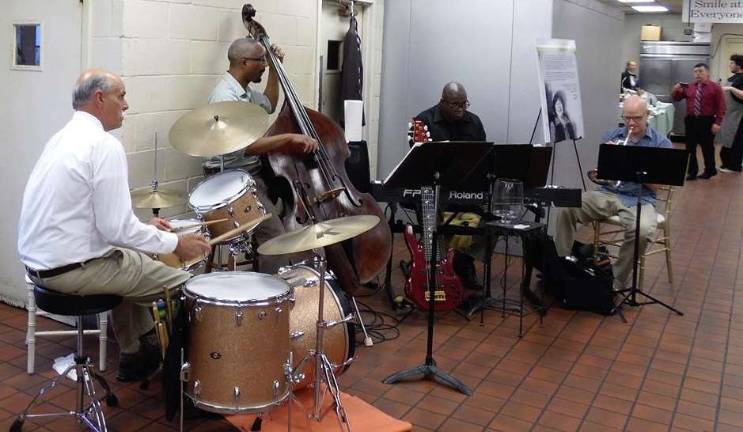 The entire building, including the kitchen, was included in the event. Here a band entertains guests as they stroll through the kitchen at Perona Farms.