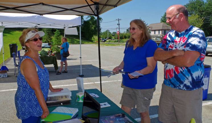 At the right, Barbara and Mark Whitman of Barry Lakes share a laught with chamber treasurer Kyle Brandt, an independent associate of Viridian Energy. The event was the Vernon Chamber of Commerce&#xfe;&#xc4;&#xf4;s first Farm Expo.