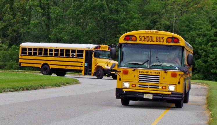 The first of 13 full-size school buses begin to arrive at Glen Meadow Middle School. Additional buses arrived in front of the school.