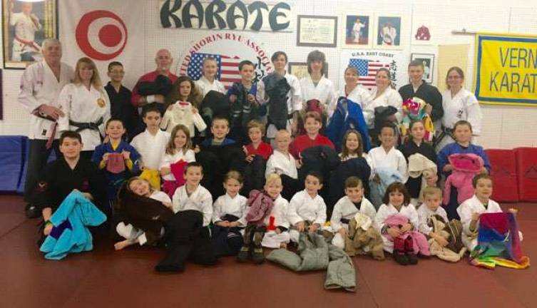 Students at the Vernon Valley Karate Academy donate clothes they collected to benefit families in need during these cold winter months.