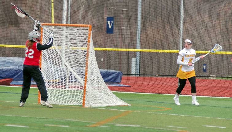 Vernon's Kathleen Smaldone stalks the goal post as Lakeland's goalkeeper Sarah Deighan stands guard.