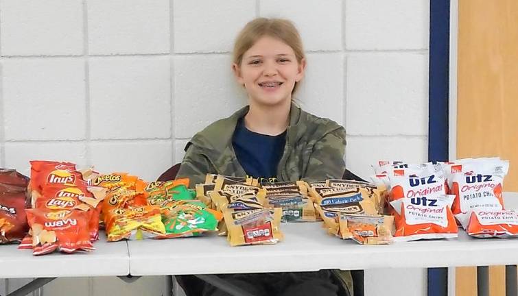 Glen Meadow hosts Game Night A student hands out snacks.
