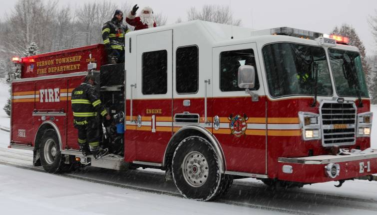 Santa waves from a Vernon Township fire truck.