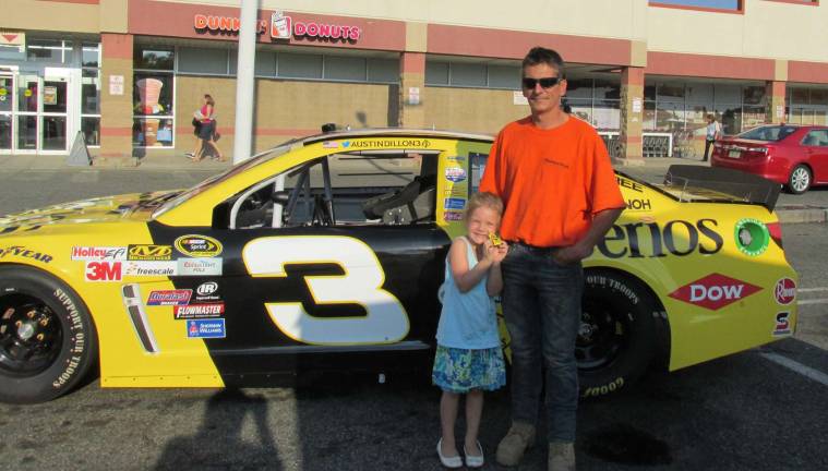 RoNetco raising money to fight hunger Tim Clark and daughter, Jessica Clark, of Andover are shown with the race car.