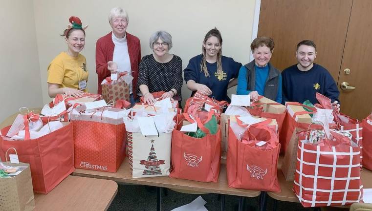 Gift bags are assembled for distribution to local senior citizens in need as part of Project Self-Sufficiency’s Earth Angels initiative (Photo provided)