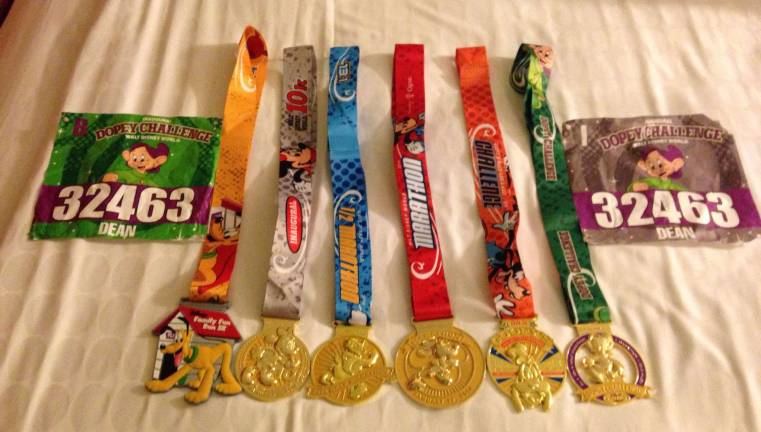 Locals go a little Dopey for Disney World races Dean shows off his awarded medals and race bibs.