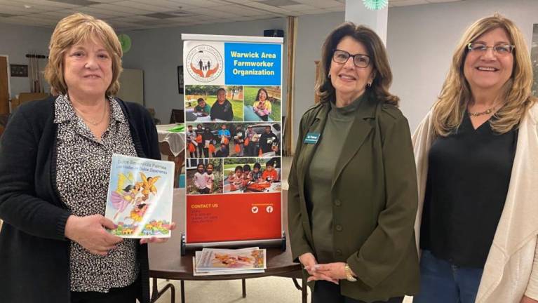 Kathy Brieger, executive director of the Warwick Area Farmworkers Organization (left), chats with Vernon Township Woman’s Club members, from left, MJ Palmer and Karen Rothstadt after the clubwomen donated cases of art supplies to the Dulce Esperanza summer program. Brieger is holding her book which was inspired by children in the program.