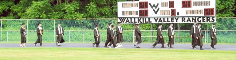 Students pass the 2020 scoreboard. (Photo by Vera Olinsky)