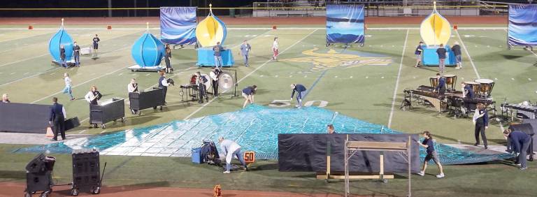 Dedicated parents and students prepare the field for the Vernon Township High School Viking Marching Band