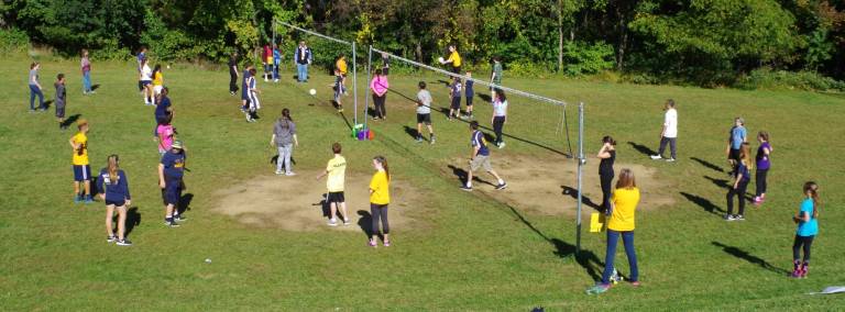 Four volleyball teams are shown competing.