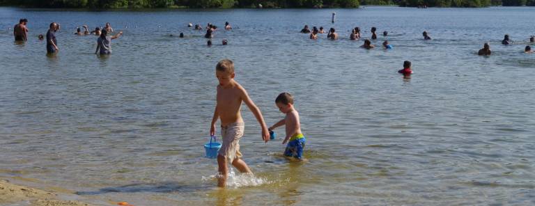 These two boys spent half their time building a sand castle and the other half in the water.