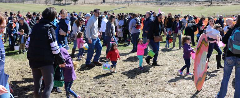Parents bring their children to the Easter Egg hunt.