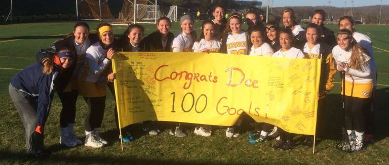 The Vernon girls lacrosse team congratulates Danielle Ward, who scored her 100th goal in a recent game against the Blair Academy. Vernon won the game, 9-8.