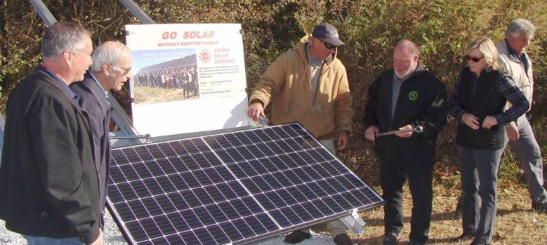 Officials torque one of the solar panels.