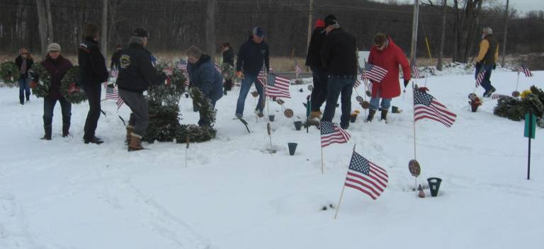 Group removes wreaths at season's end The many volunteers removed and tidied up the graves at the cemetery.