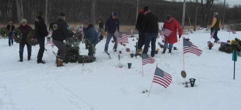 The many volunteers removed and tidied up the graves at the cemetery.