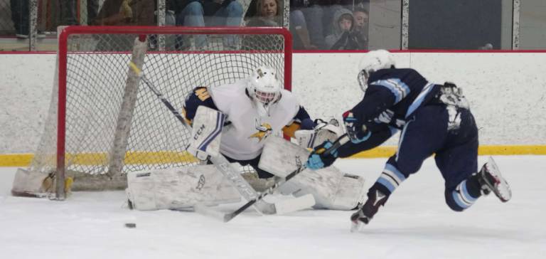 In the second period Vernon's goalie Jacob King drops down to the ice to defend against an encroaching West Morris Central player whose shot attempt sends the puck off to the side. King made 17 saves.