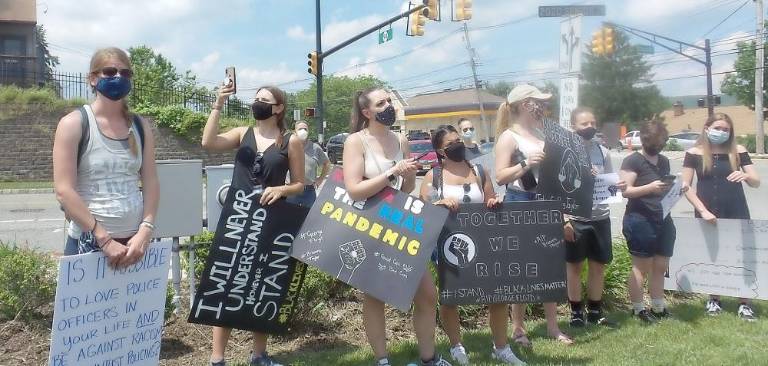 Many lined the sidewalk in front of CVS. Many also stood in the grassy area and held signs. People kept coming and many said 200+ came to protest against racism.