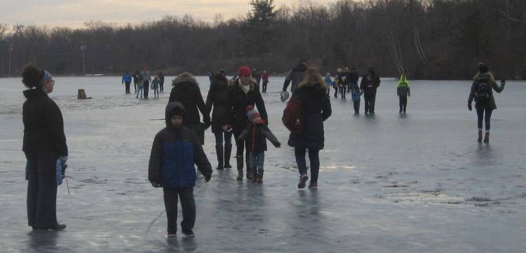 Visitors on ice do some fishing and some curling.