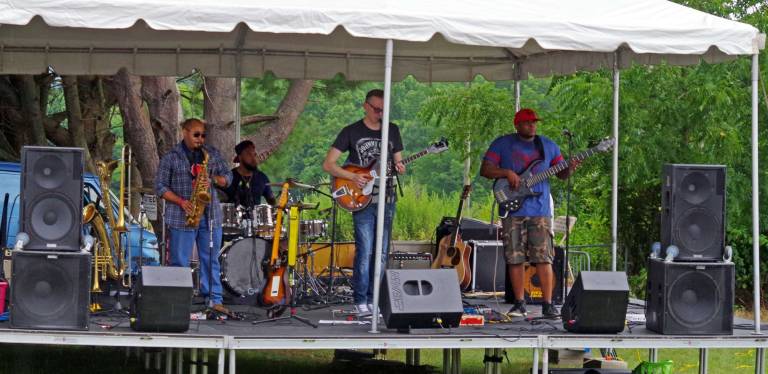 The Bryan Hansen band is shown performing before the rains started on Saturday afternoon.