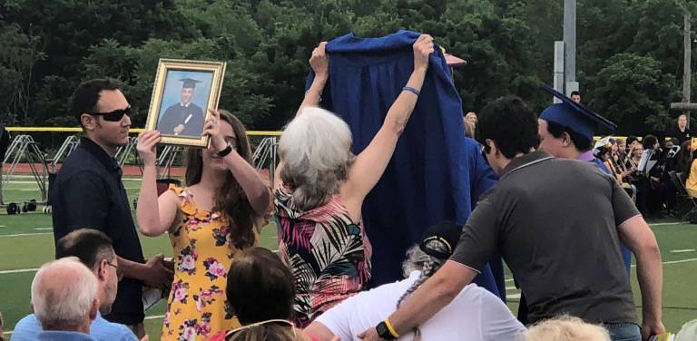 Vernon seniors graduate into future PHOTOS BY ROSEMARY MCGUIREThe family of Vinny Ventriglia, ,who died earier this school year from cancer, holds up his photo and graduation robe.