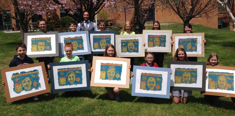 Daniel Burke, Langdon Frey, Kate Blackmore, Caitlin Witters, Leandra McMahon, Sarah Begg, Nathan Henry, Grace Loggie, Brianna VanOrden, Leah Nistok, Noel Debonta, and Anna Dayon, all fifth-grade art students from Lounsberry Hollow, along with Art Teacher Mr. Villanueva, show off their self-portrait treasure maps, which will be on display at Vernon Township&#xfe;&#xc4;&#xf4;s Board of Education building during May.