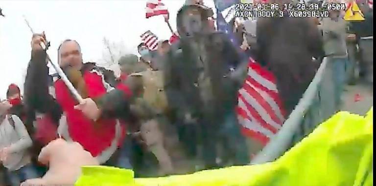 Ex-NYPD officer and Marine charged in violent Capitol attack Federal authorities say Orange County resident Thomas Webster is pictured on the left in this photo, raising a flag pole with a U.S. Marine flag.