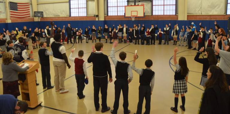 Ninety-seven students from Pope John XXIII Regional High School, Pope John XXIII Middle School and Reverend George A. Brown Memorial School perform a group activity in which they had to find a new buddy after listening to the story, &quot;Life of the Wright Family,&quot; during a Linking Lions meeting in November at Reverend George A. Brown memorial School in Sparta.