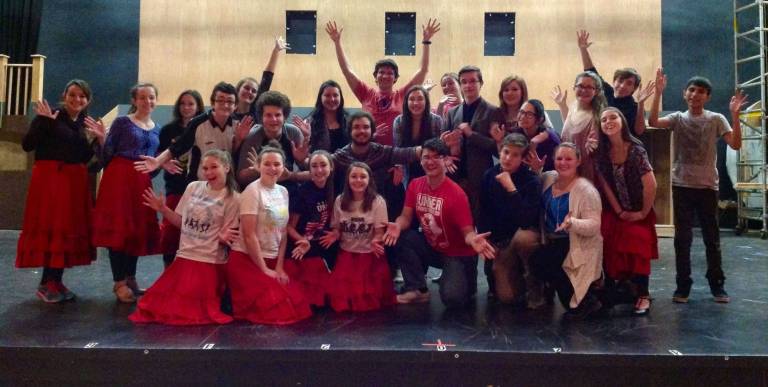The cast pauses for a group picture during rehearsal.