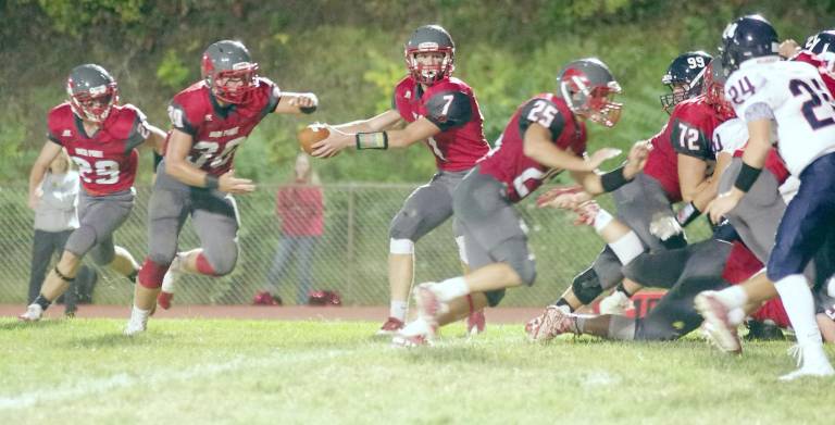 High Point running back Travis Tallamy is about to grab the ball from quarterback Alex Buchwald during a hand-off play early in the game. Tallamy rushed for 102 yards resulting in two touchdowns. Buchwald scored a running touchdown and threw a touchdown pass