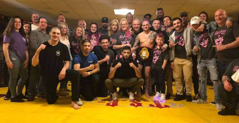Miller Brothers MMA members celebrate the victories at PA Cage Fight by Tyler Bayer (Front left), Cristian Santos (Front center) and Sean Santella (Middle, Belt).